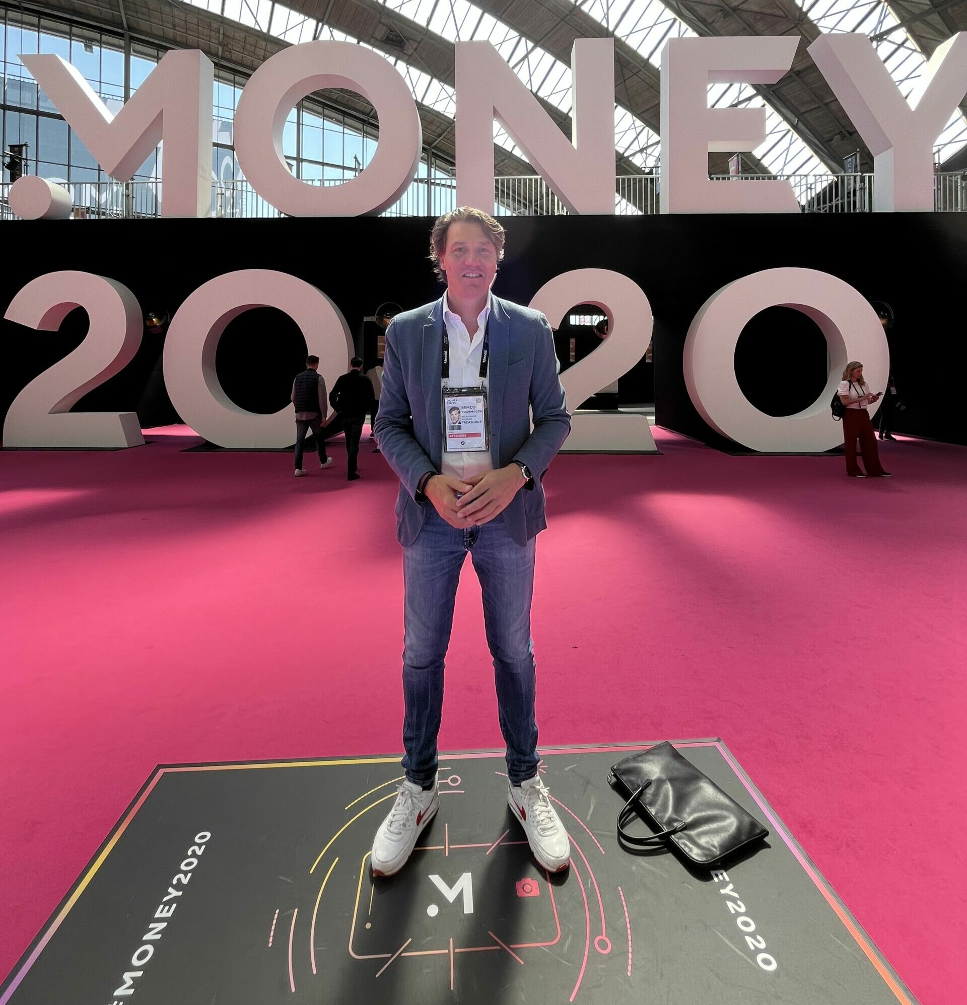 A professional photograph capturing Remco, the Relationship Manager at TreasurUp, during his visit to Money2020 2023 in Amsterdam. Remco is seen confidently engaging with event attendees, representing TreasurUp and fostering valuable connections within the finance and fintech industry.